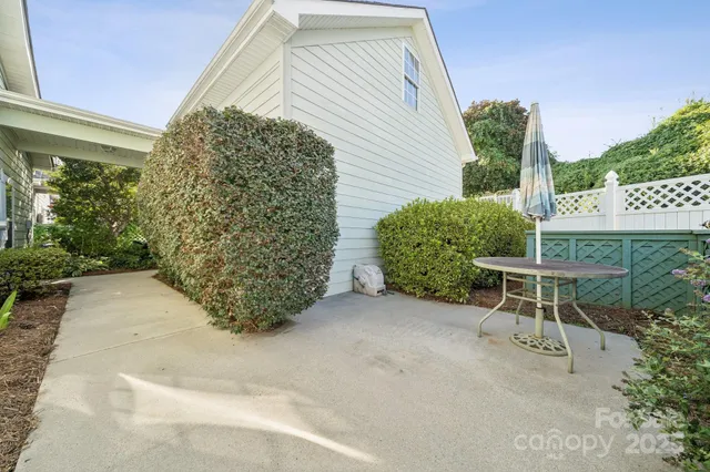a view of a chairs and table in the backyard