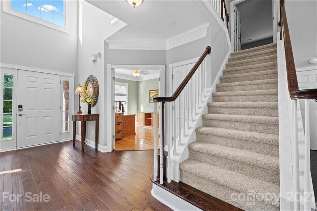 1743 Bentgrass Lane Tega Cay, SC 29708 - Photo 2 of 47 a view of an entryway with wooden floor and stairs