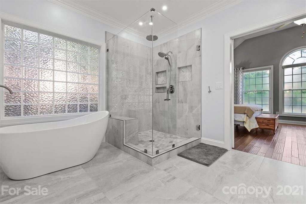 1743 Bentgrass Lane Tega Cay, SC 29708 - Photo 21 of 47 a bathroom with a tub shower and window