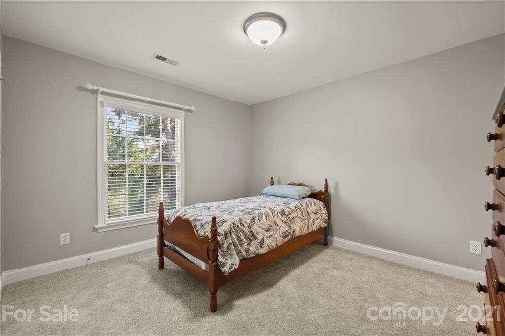 1743 Bentgrass Lane Tega Cay, SC 29708 - Photo 31 of 47 a bed sitting in a bedroom next to a window