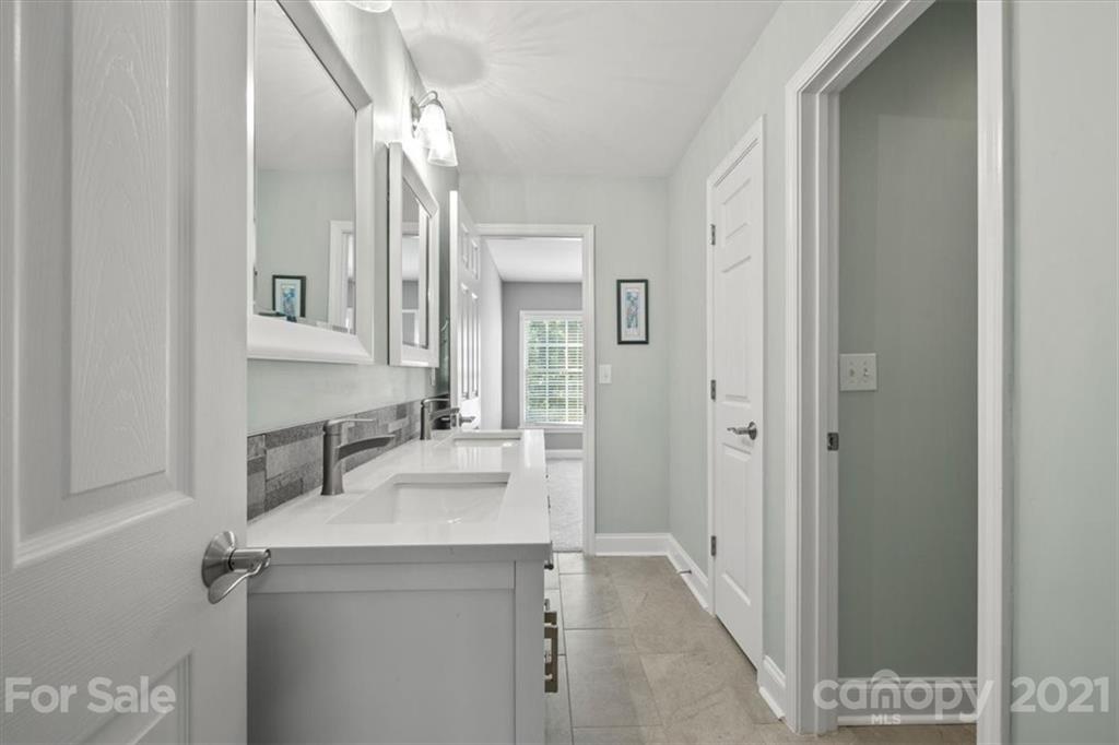 1743 Bentgrass Lane Tega Cay, SC 29708 - Photo 32 of 47 a bathroom with a sink and a mirror