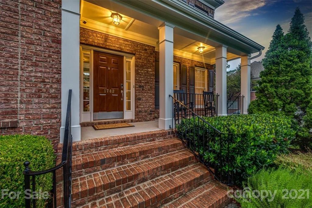 1743 Bentgrass Lane Tega Cay, SC 29708 - Photo 46 of 47 a view of a house with a large windows and flower plants