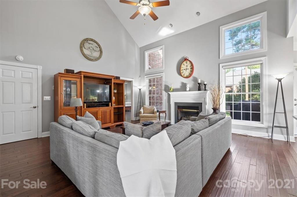 1743 Bentgrass Lane Tega Cay, SC 29708 - Photo 7 of 47 a living room with furniture a flat screen tv and a fireplace