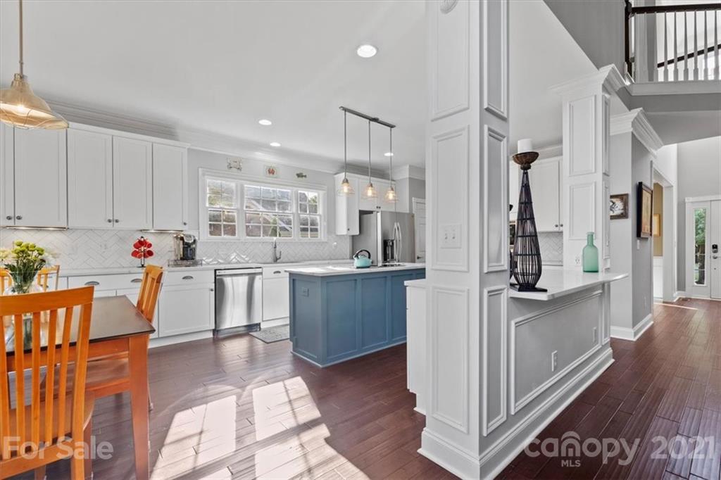 1743 Bentgrass Lane Tega Cay, SC 29708 - Photo 10 of 47 a kitchen with stainless steel appliances kitchen island granite countertop a refrigerator and a stove top oven