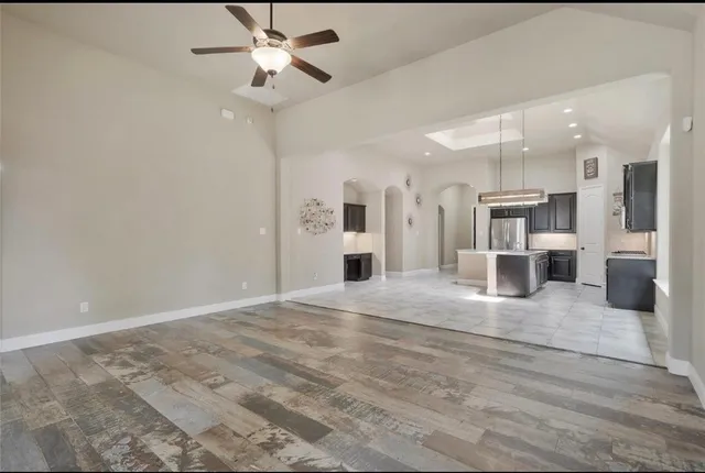 a view of a kitchen with a sink and a refrigerator