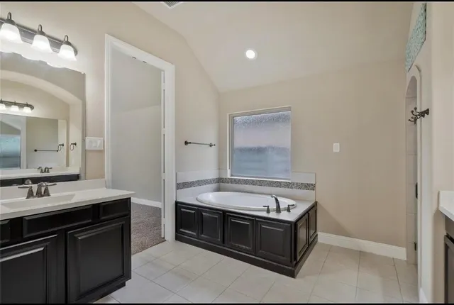 a spacious bathroom with a sink and a mirror
