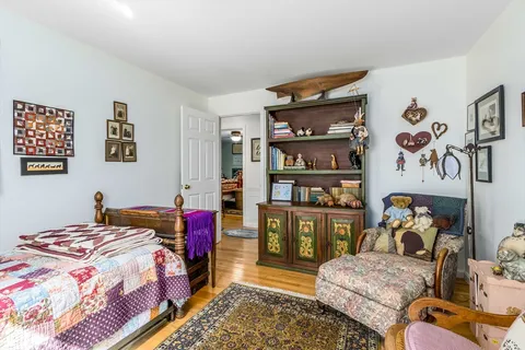 a bed room with a bed and a book shelf