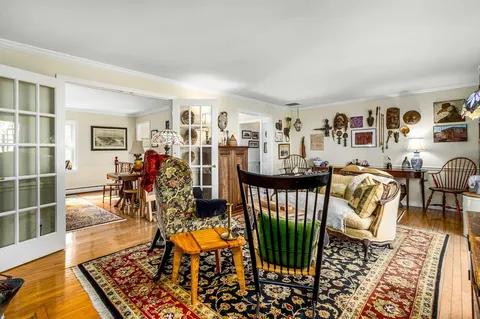 a living room with furniture rug and window