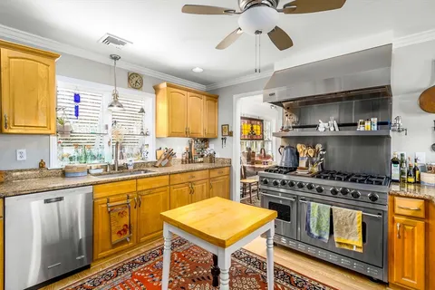 a kitchen with stainless steel appliances granite countertop a stove and a sink