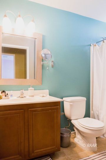1129 Rebecca Avenue Ridgecrest, CA 93555 - Photo 26 of 34 a bathroom with a toilet a sink and mirror