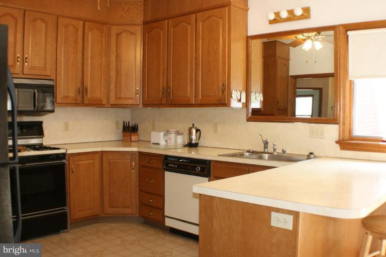8124 Stone Ridge Drive Frederick, MD 21702 - Photo 2 of 28 a kitchen with a sink a stove and cabinets