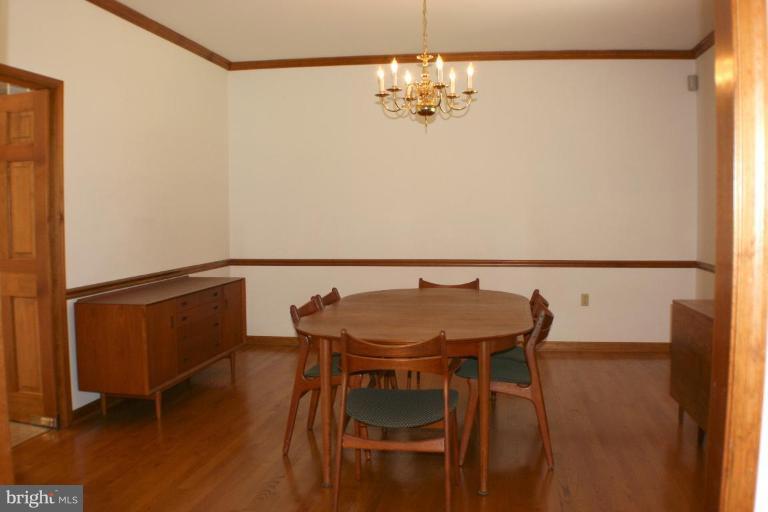 8124 Stone Ridge Drive Frederick, MD 21702 - Photo 5 of 28 a view of a dining room with furniture and wooden floor