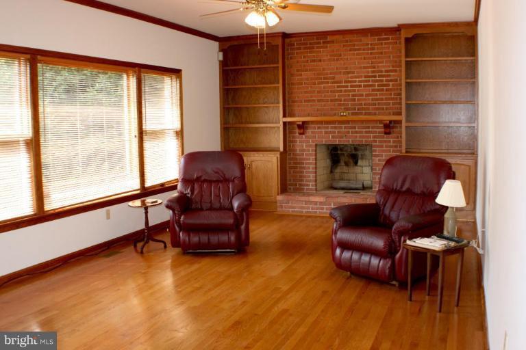 8124 Stone Ridge Drive Frederick, MD 21702 - Photo 6 of 28 a living room with furniture and a fireplace