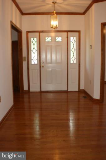 8124 Stone Ridge Drive Frederick, MD 21702 - Photo 8 of 28 an empty room with wooden floor and windows
