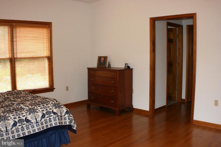 8124 Stone Ridge Drive Frederick, MD 21702 - Photo 9 of 28 a bedroom with a bed and wooden floor