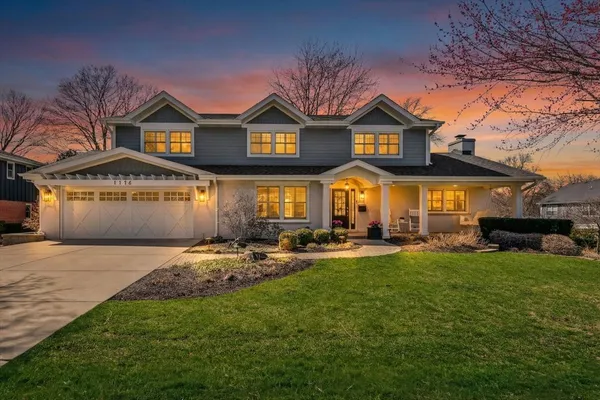 a front view of a house with swimming pool and porch