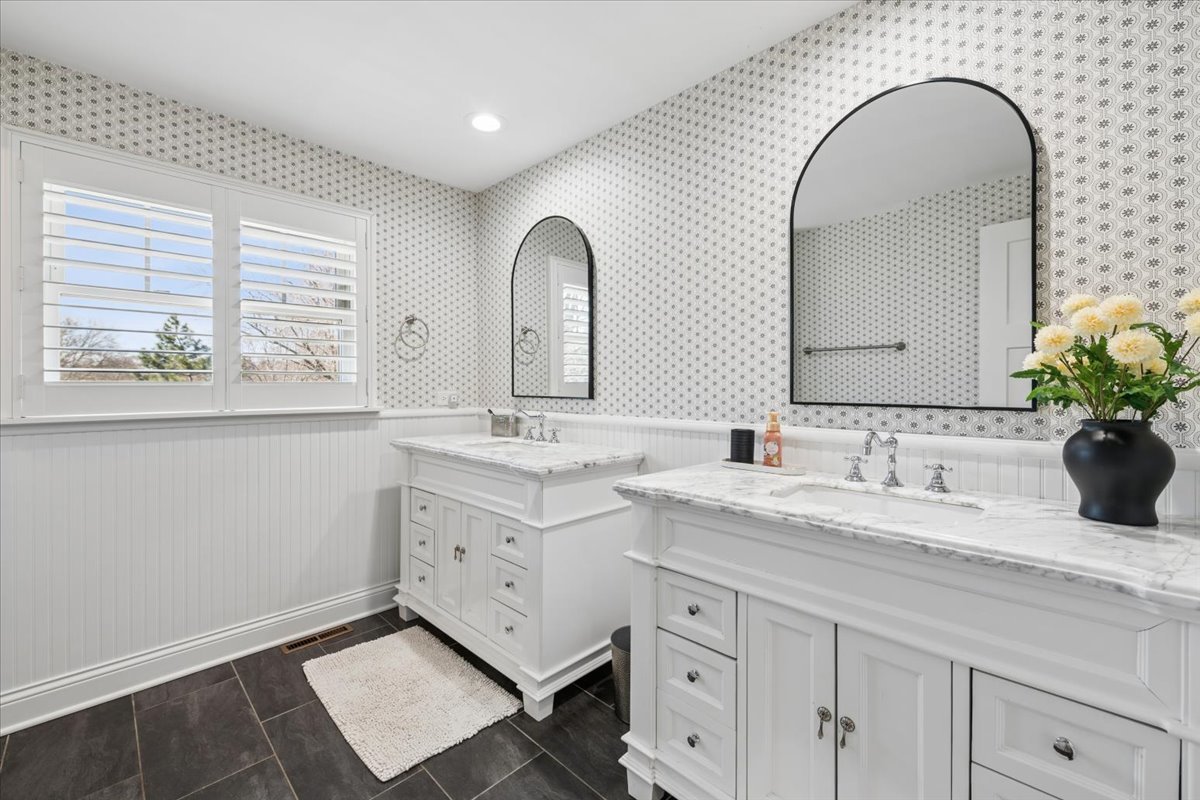 1114 Gamon Road Wheaton, IL 60189 - Photo 44 of 60 a bathroom with a granite countertop sink a large mirror and next to a window
