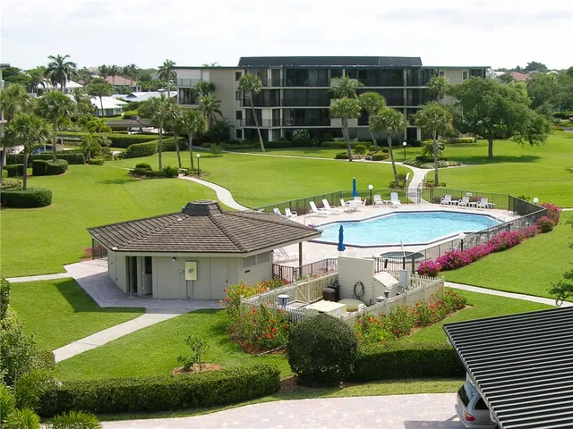 a aerial view of a house with a yard table and chairs