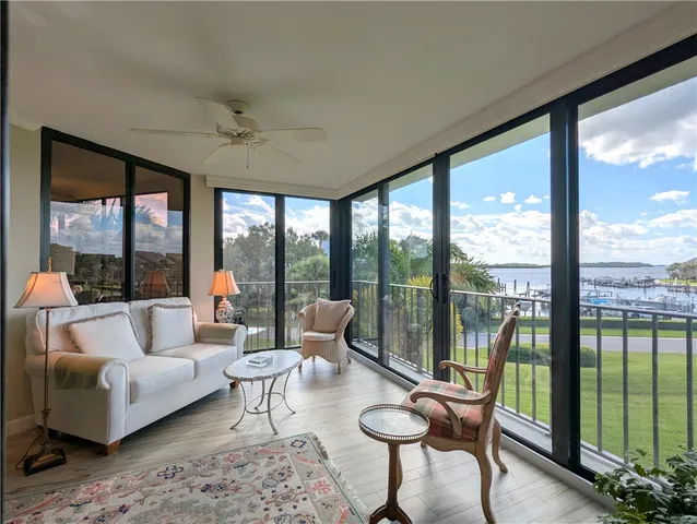 a living room with furniture and a floor to ceiling window