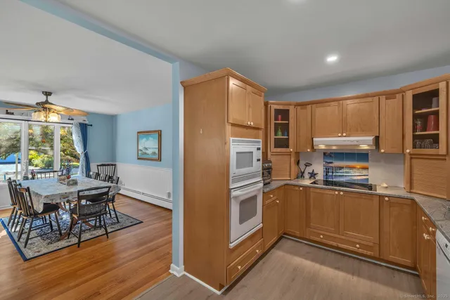 a kitchen with granite countertop stainless steel appliances and wooden cabinets