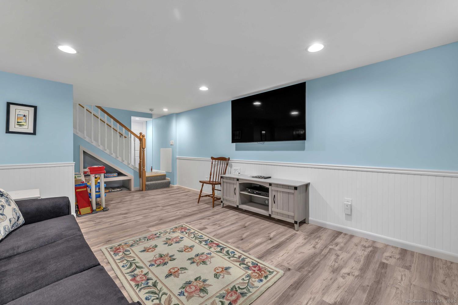 33 Fenwood Road Old Saybrook, CT 06475 - Photo 24 of 37 a living room with furniture and a flat screen tv