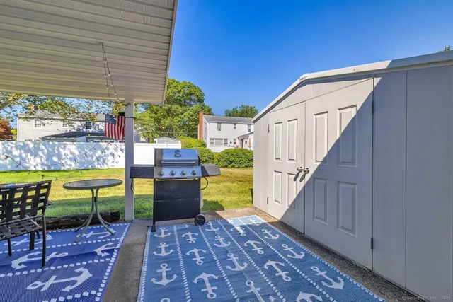 a view of a patio with table and chairs potted plants with wooden floor