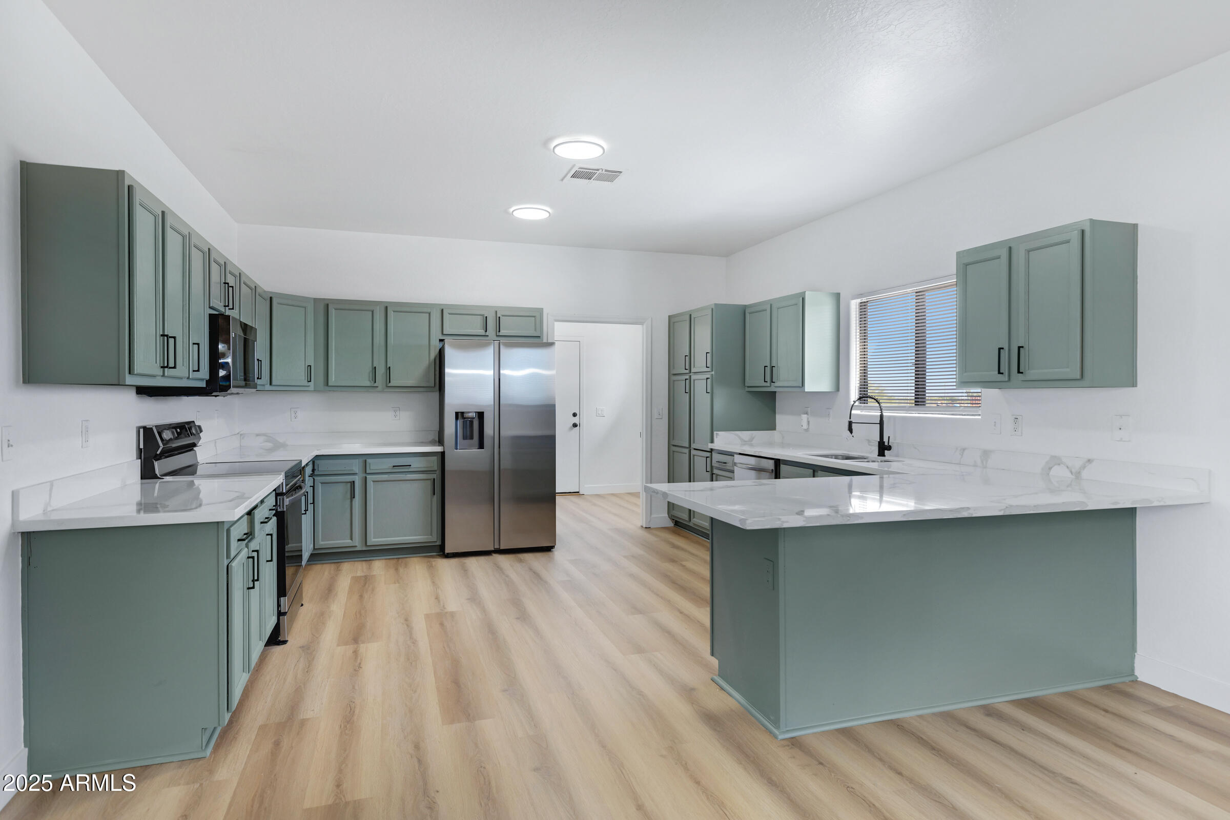 34247 West Pecan Road Tonopah, AZ 85354 - Photo 11 of 31 a kitchen with stainless steel appliances a sink stove and refrigerator