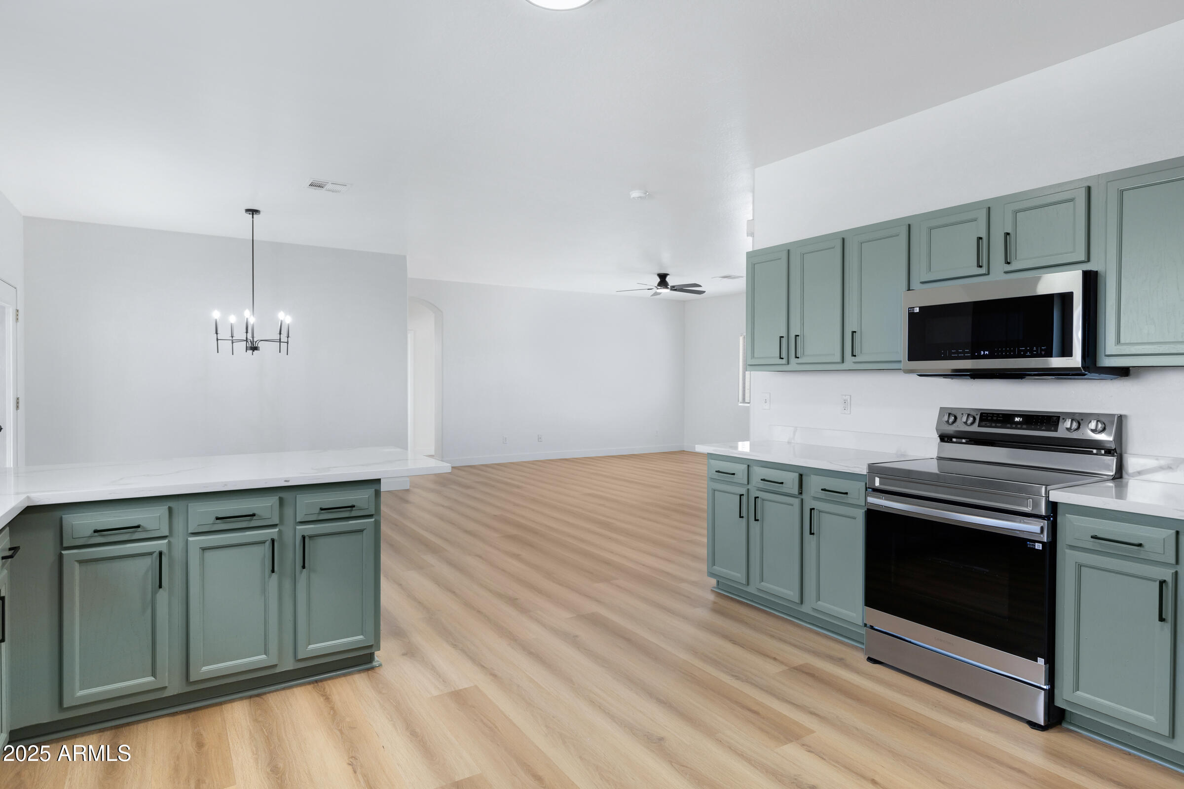 34247 West Pecan Road Tonopah, AZ 85354 - Photo 15 of 31 a kitchen with stainless steel appliances granite countertop a stove and a microwave