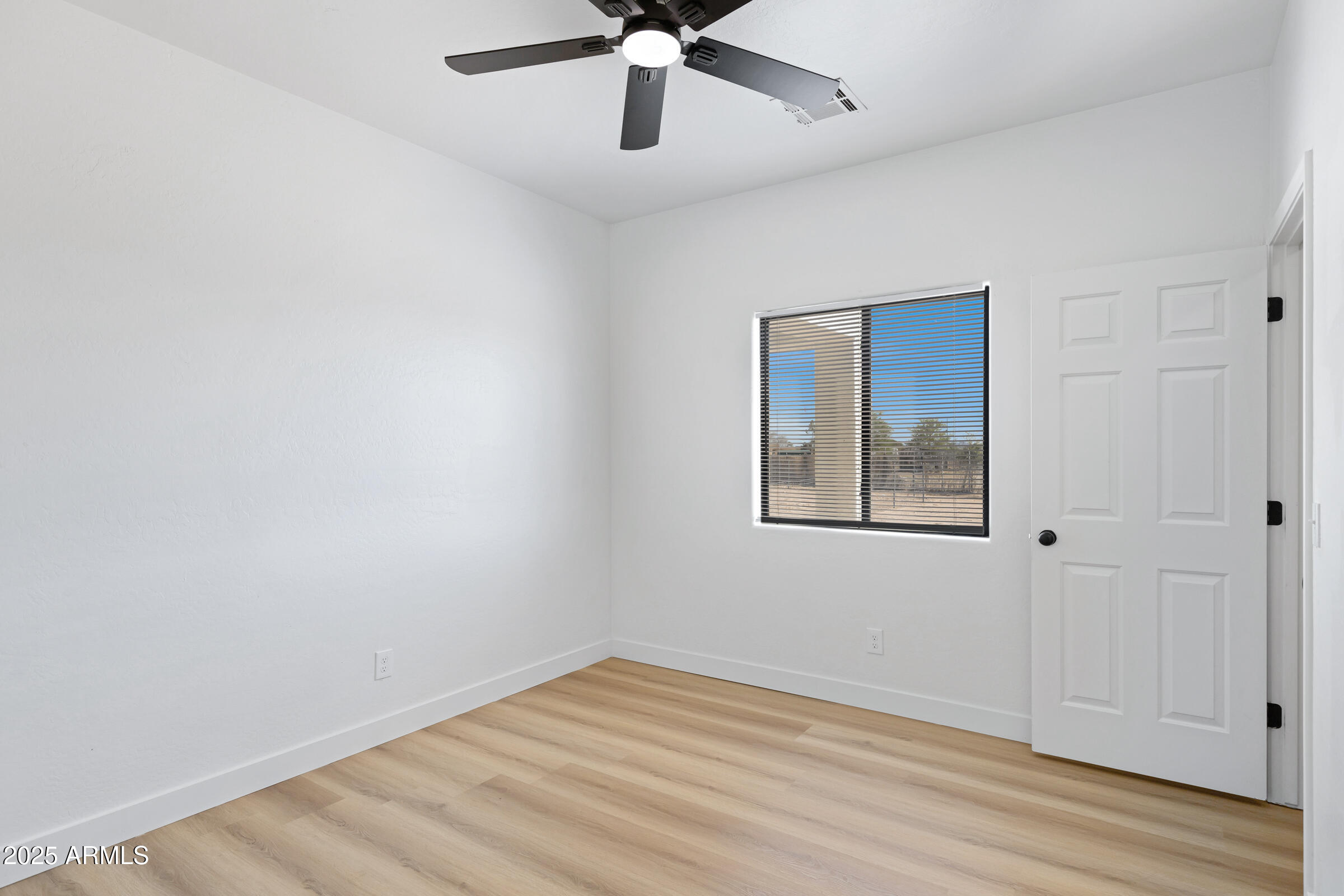 34247 West Pecan Road Tonopah, AZ 85354 - Photo 17 of 31 wooden floor in an empty room with a window