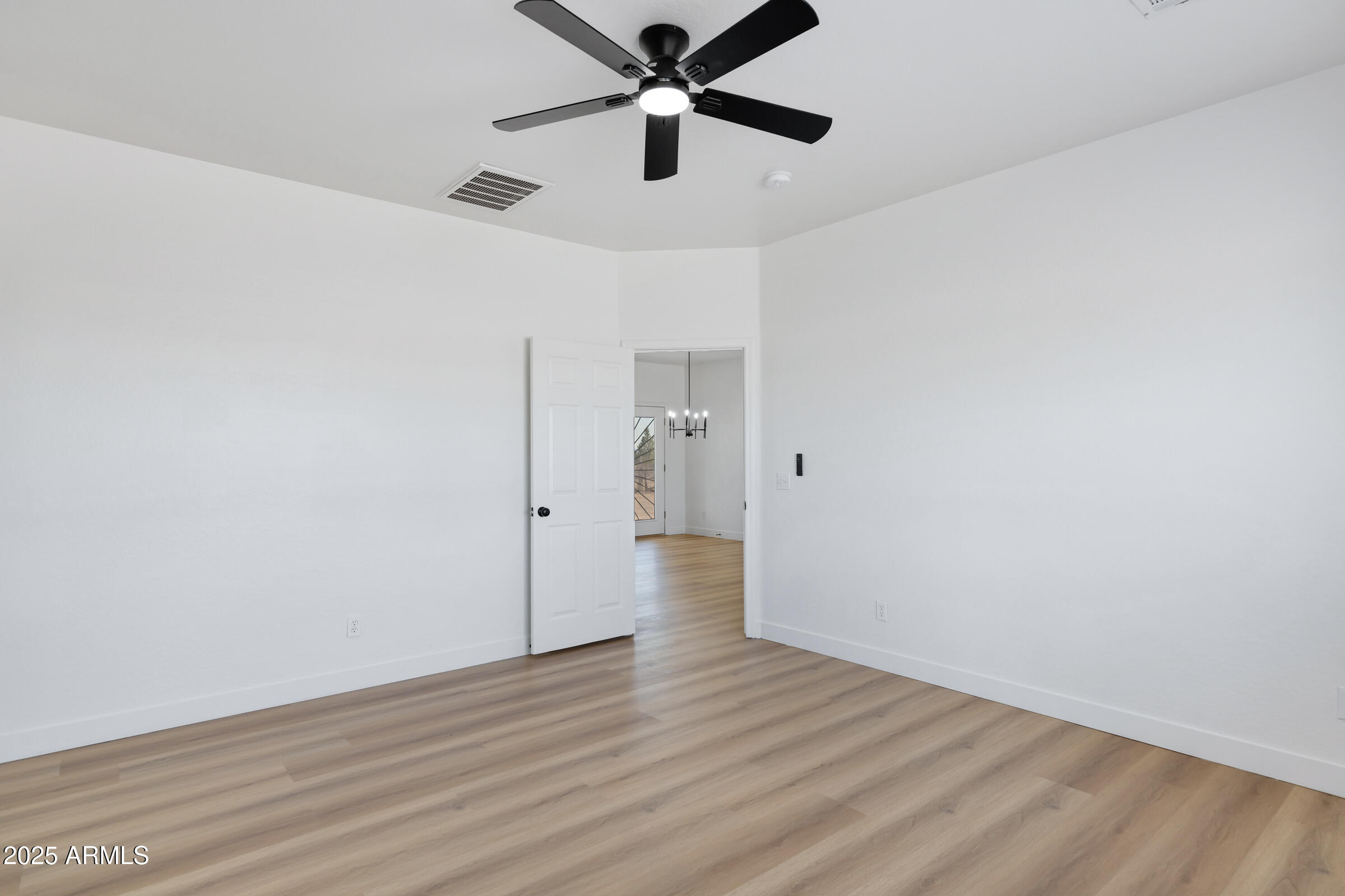 34247 West Pecan Road Tonopah, AZ 85354 - Photo 22 of 31 a view of empty room with wooden floor
