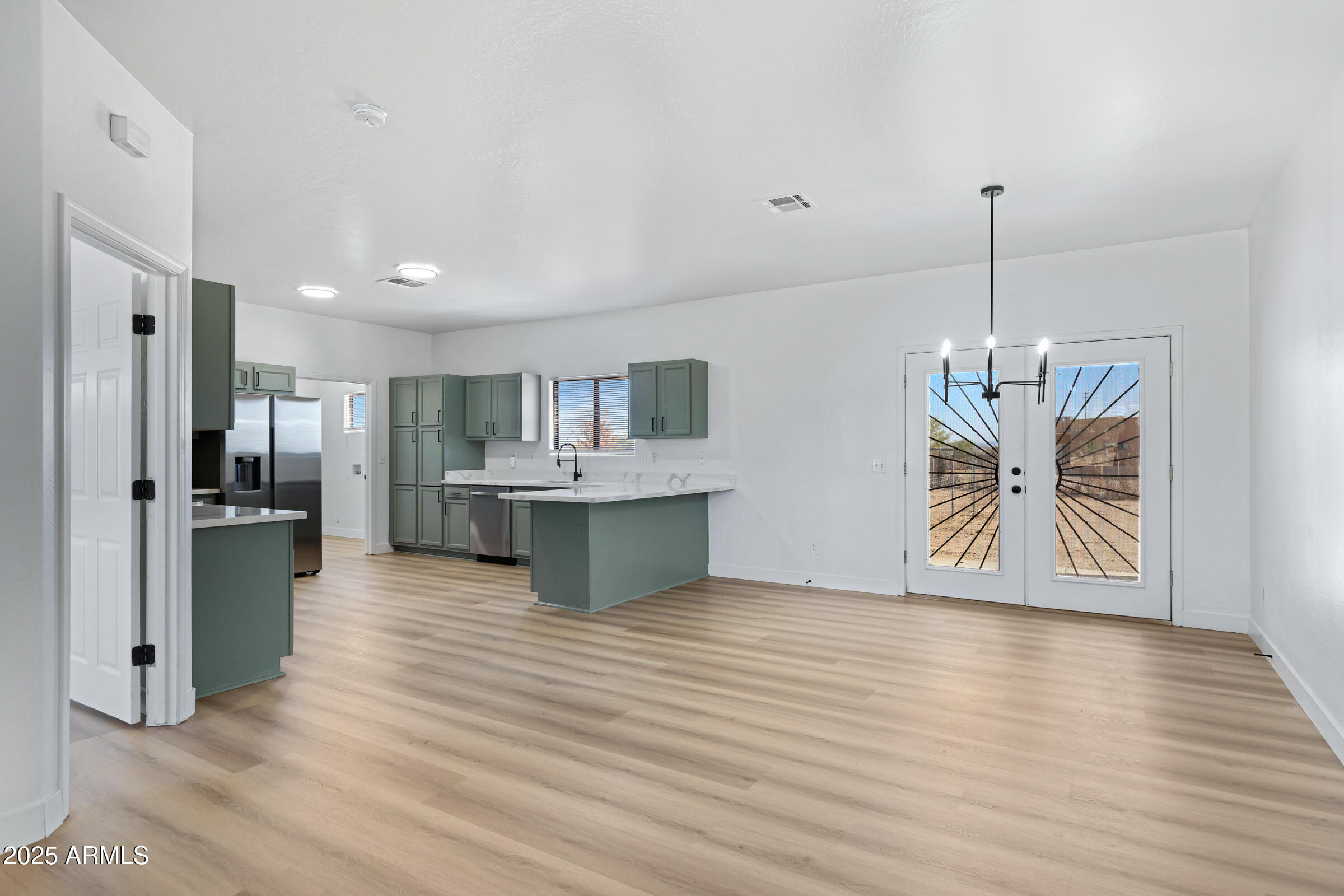 34247 West Pecan Road Tonopah, AZ 85354 - Photo 9 of 31 a view of kitchen with refrigerator microwave and wooden floor