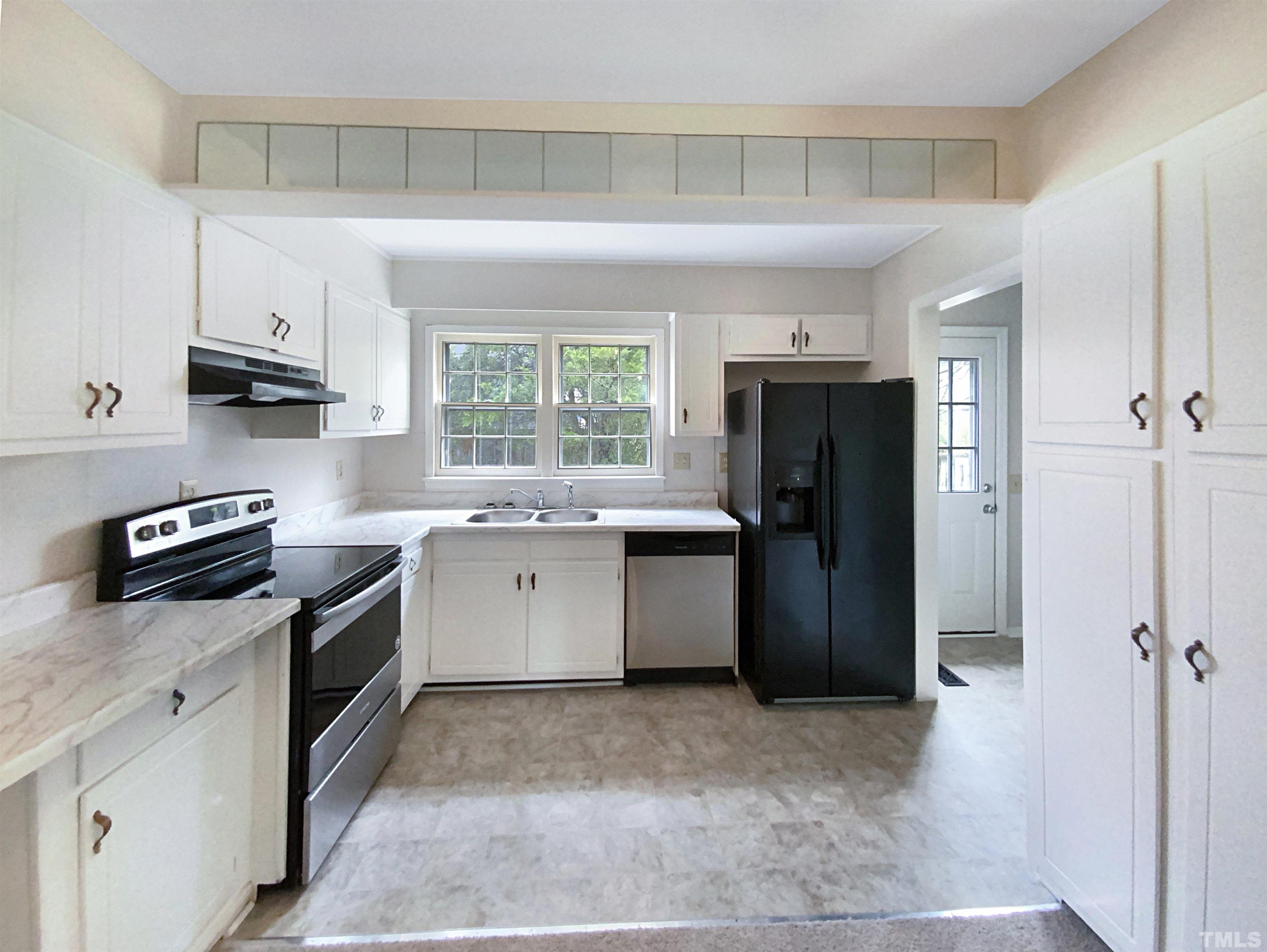 1344 Sedwick Road Durham, NC 27713 - Photo 2 of 16 a kitchen with a sink stove and refrigerator