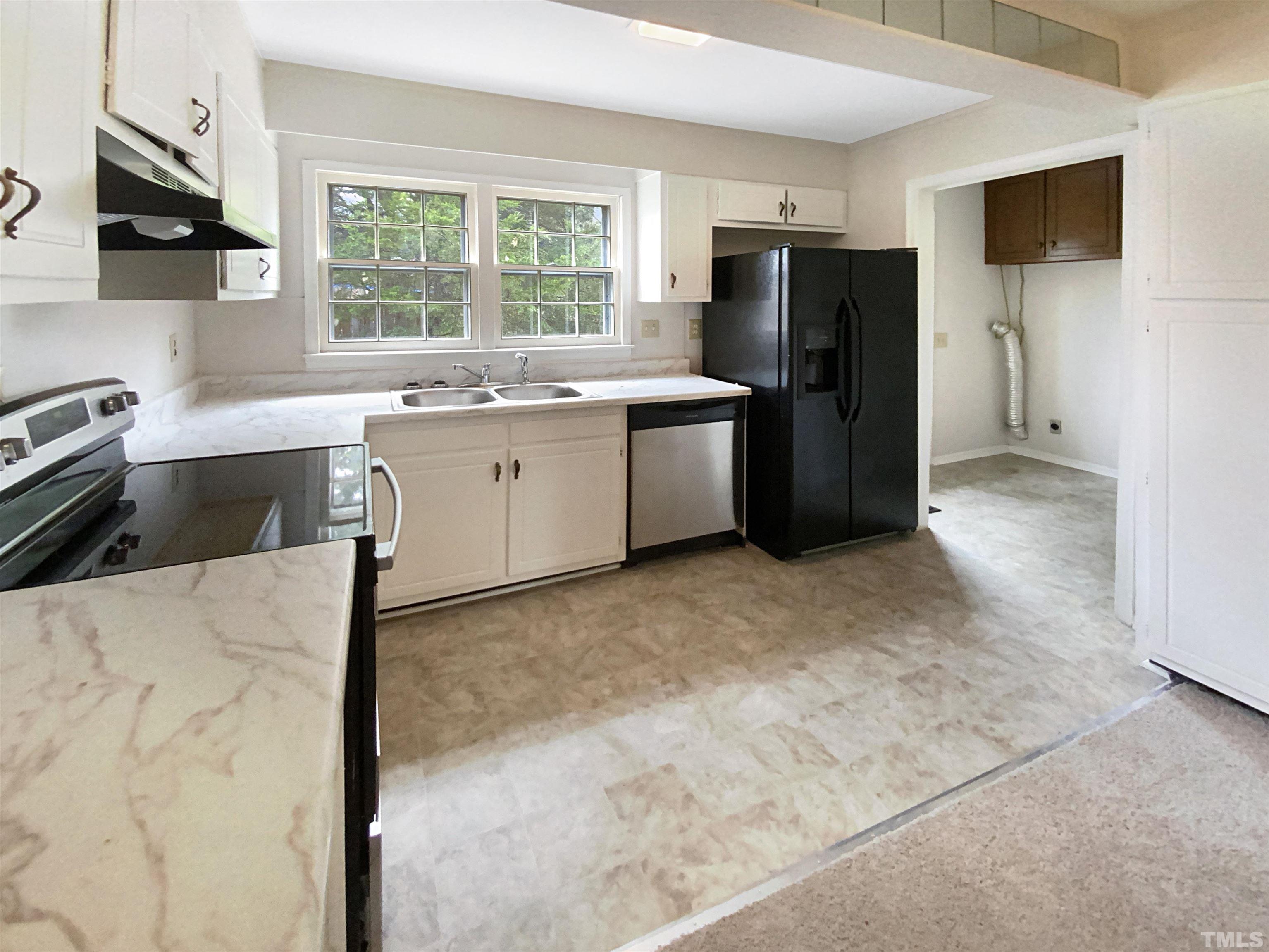 1344 Sedwick Road Durham, NC 27713 - Photo 8 of 16 a kitchen with a refrigerator and a sink