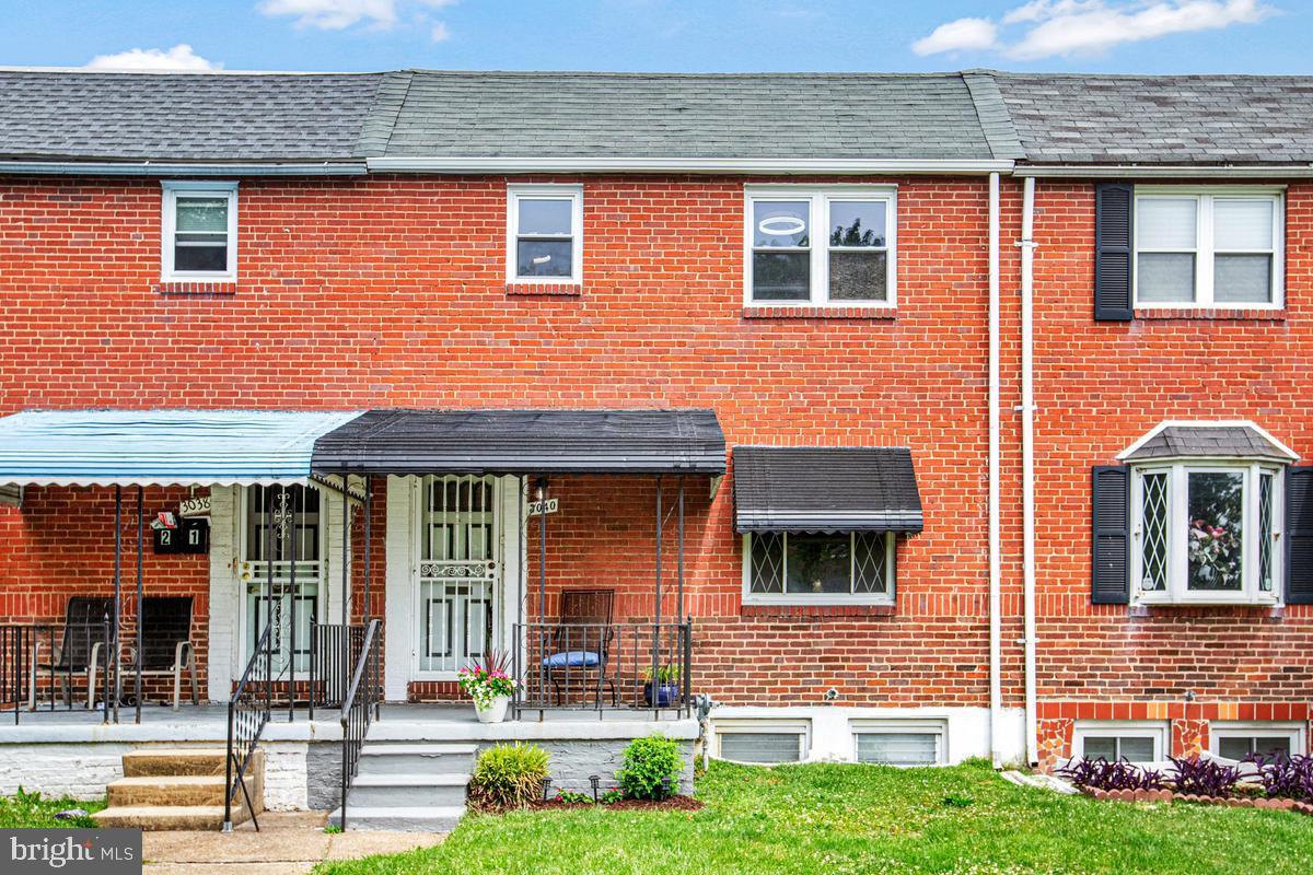 a front view of brick house with a yard