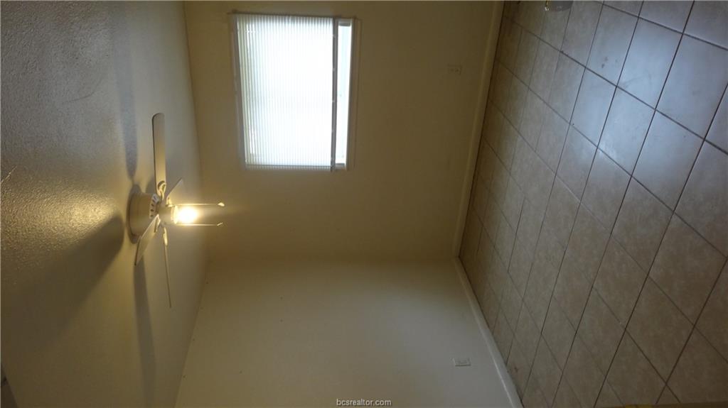 510 Avondale Avenue, Unit 14 Bryan, TX 77802 - Photo 9 of 13 a view of an empty room with a window