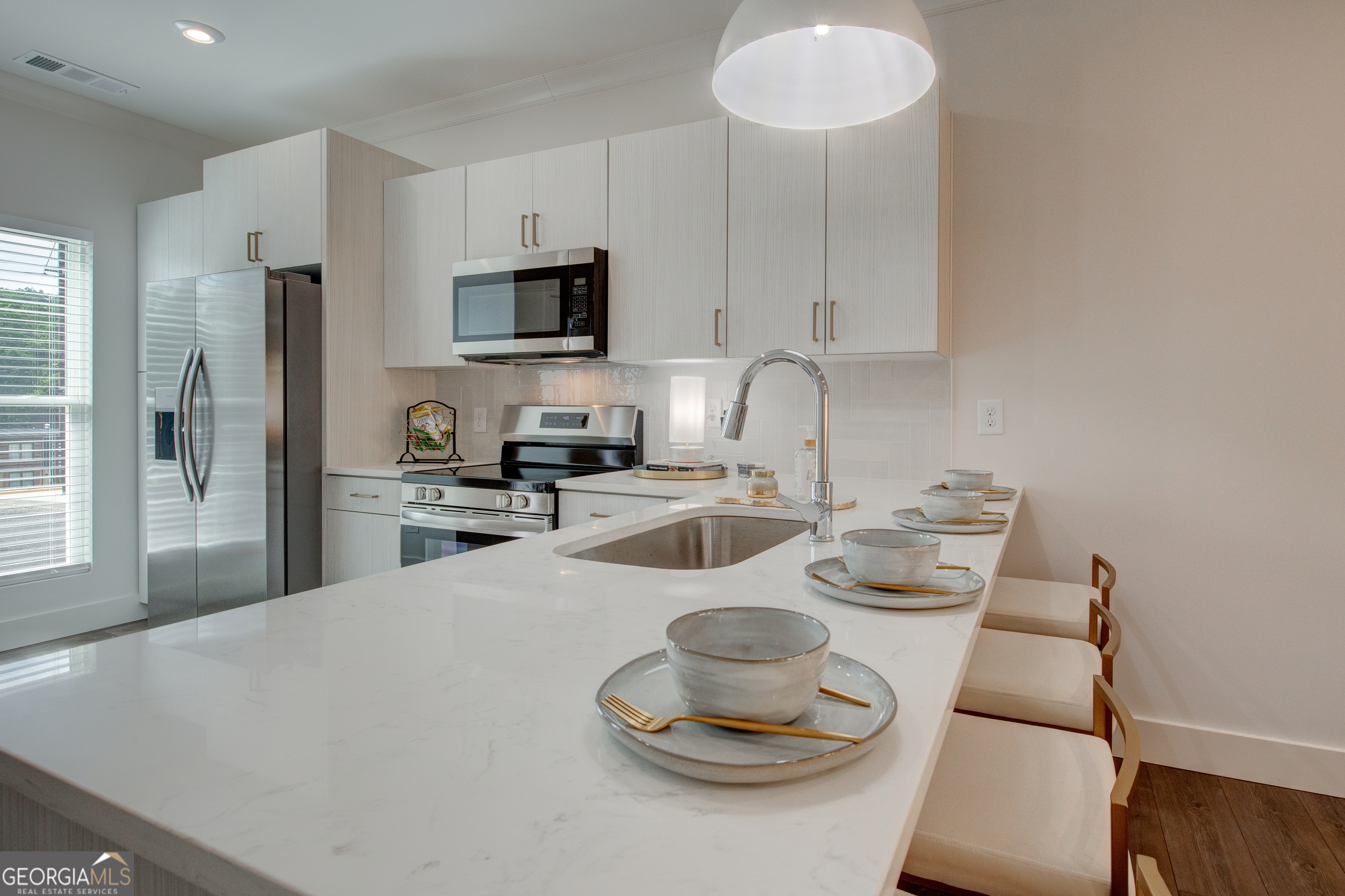 79 Chateau Drive Southeast Rome, GA 30161 - Photo 15 of 46 a kitchen with stainless steel appliances a sink a stove a microwave a refrigerator and cabinets