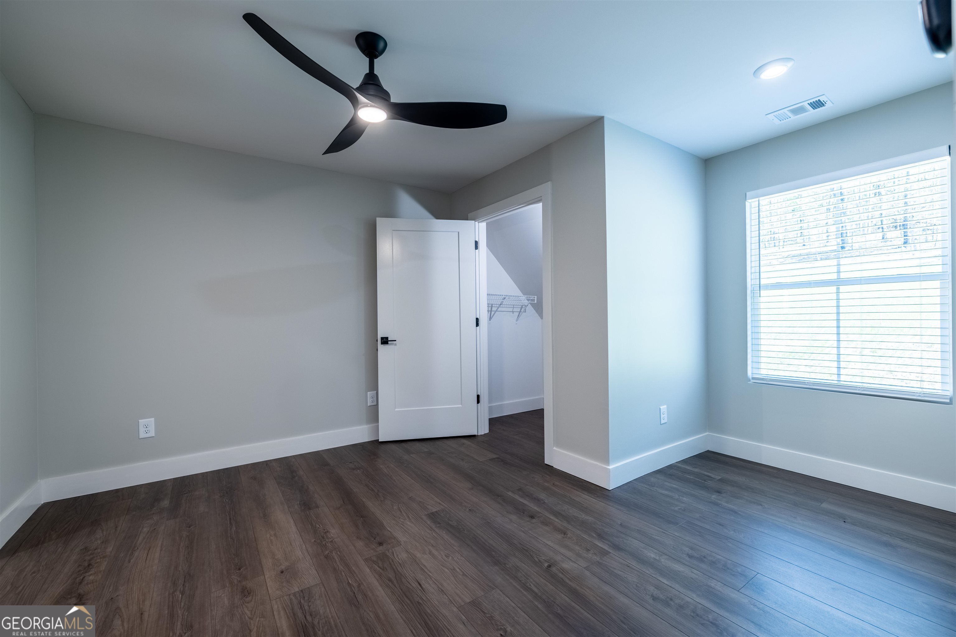 79 Chateau Drive Southeast Rome, GA 30161 - Photo 29 of 46 an empty room with wooden floor ceiling fan and windows