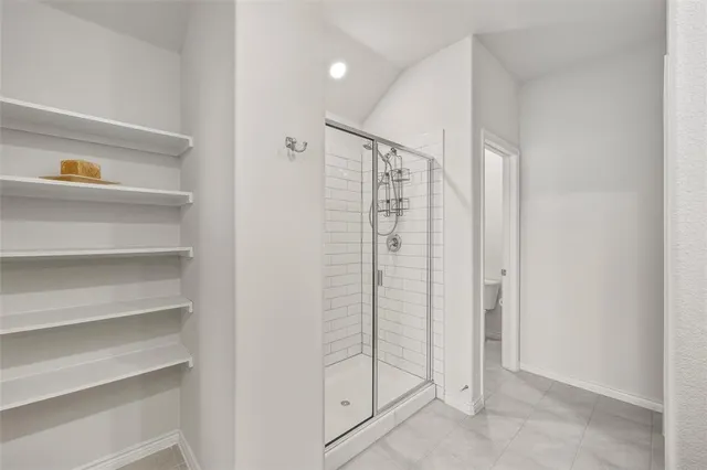 a bathroom with a shower and a sink