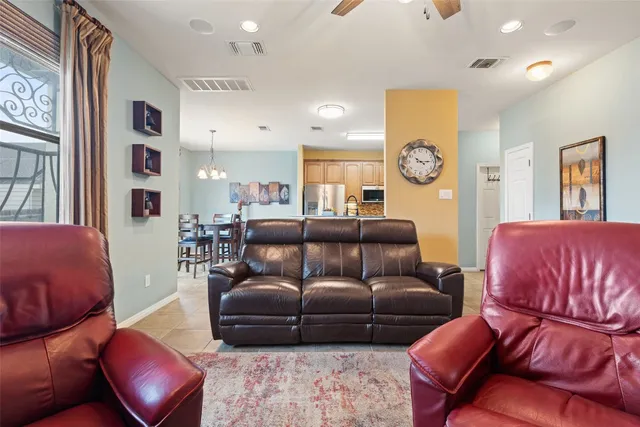 a living room with furniture a flat screen tv and potted plant
