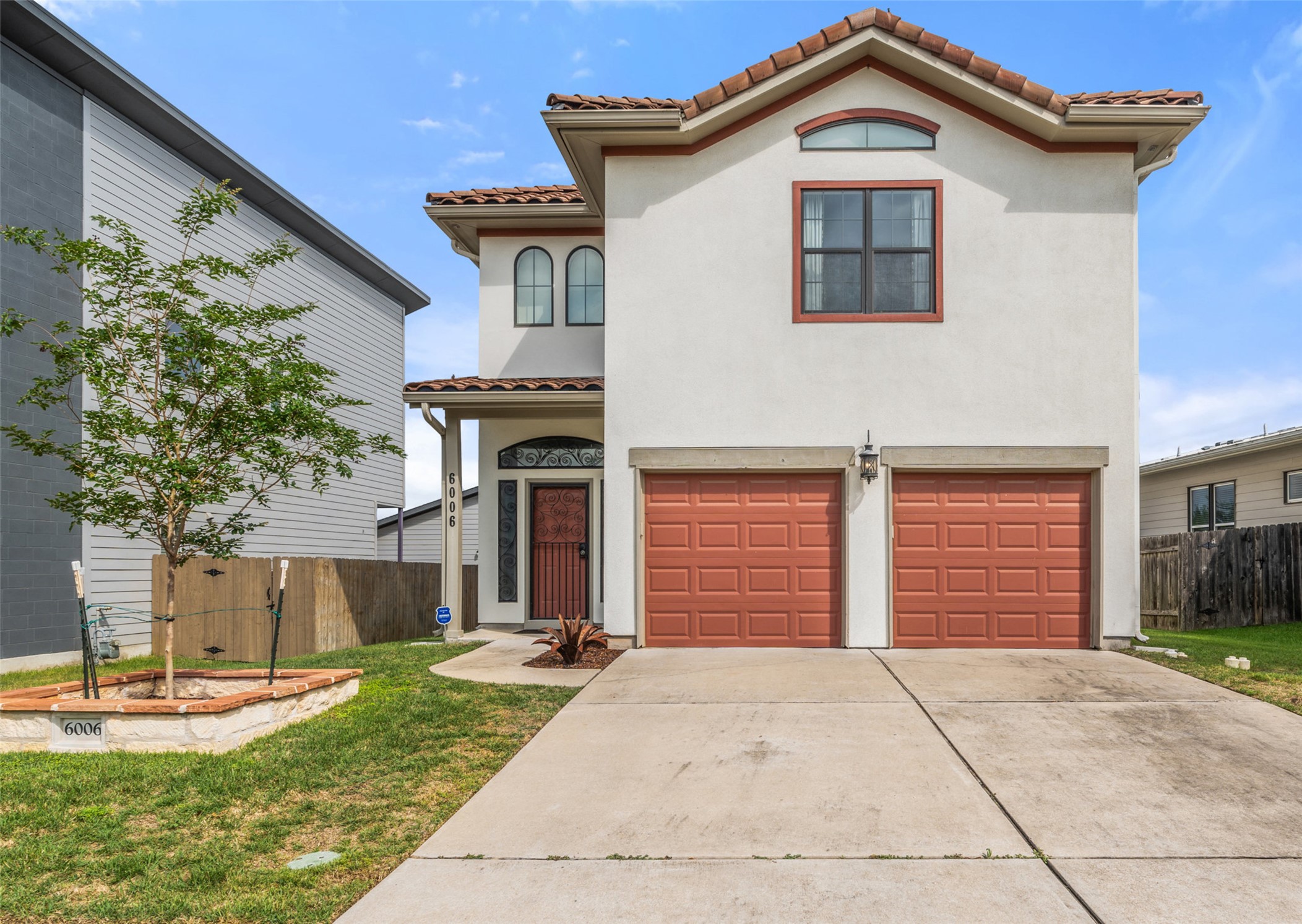 6006 Seville Drive Austin, TX 78724 - Photo 2 of 38 a front view of a house with garden
