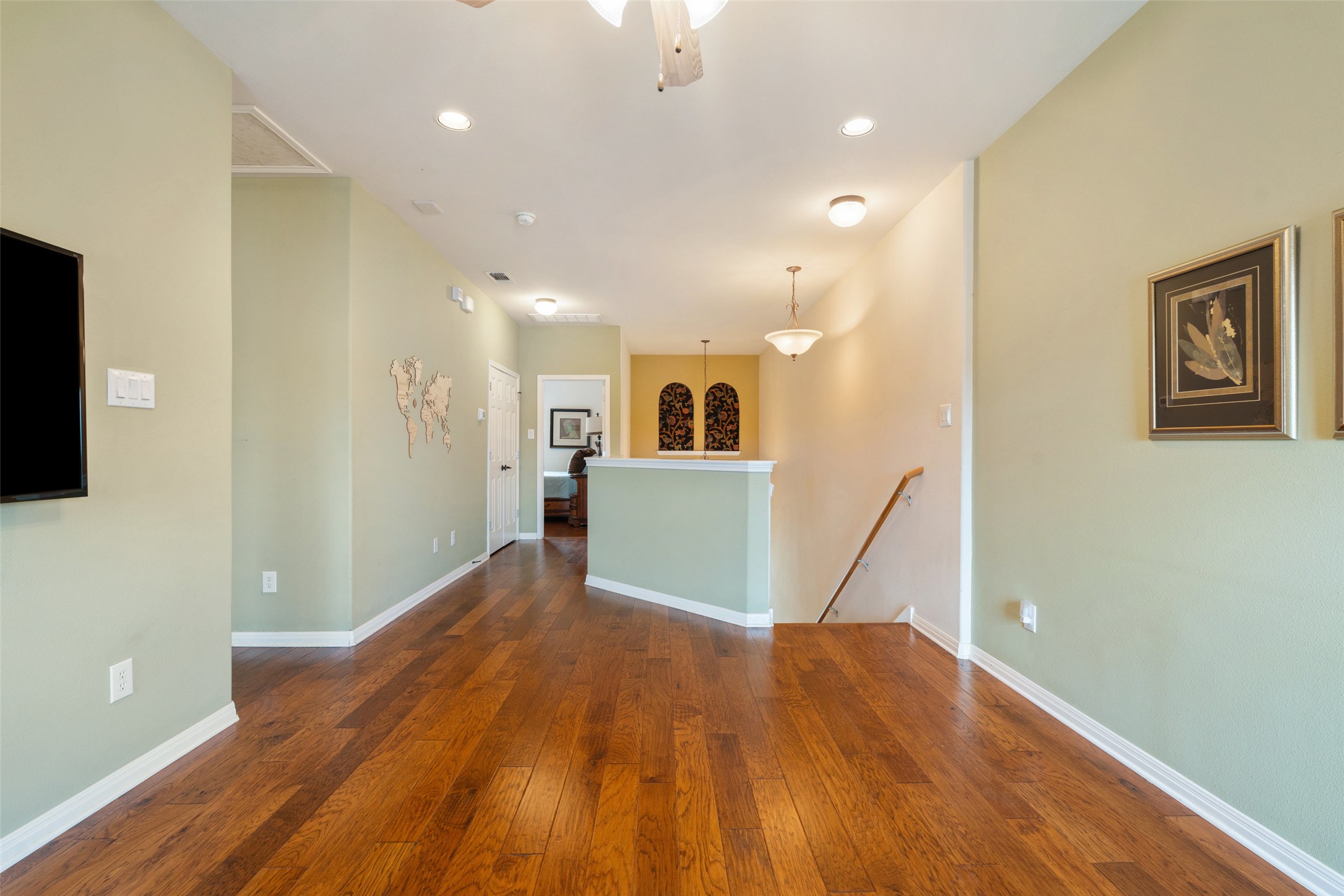 6006 Seville Drive Austin, TX 78724 - Photo 20 of 38 a view of a big room with wooden floor and a kitchen