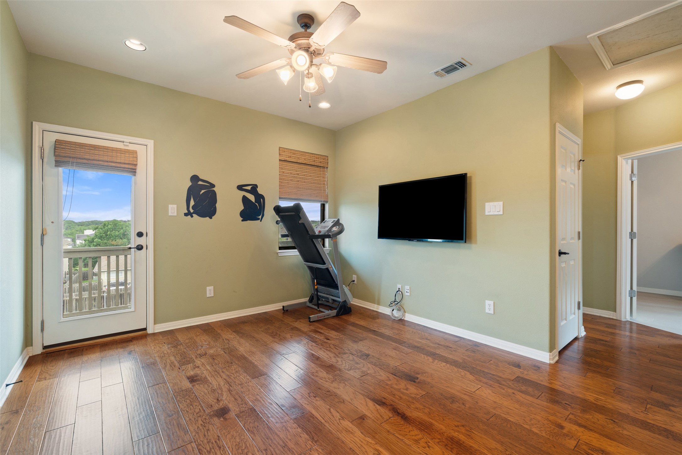 6006 Seville Drive Austin, TX 78724 - Photo 21 of 38 a view of a workspace with furniture and a flat screen tv