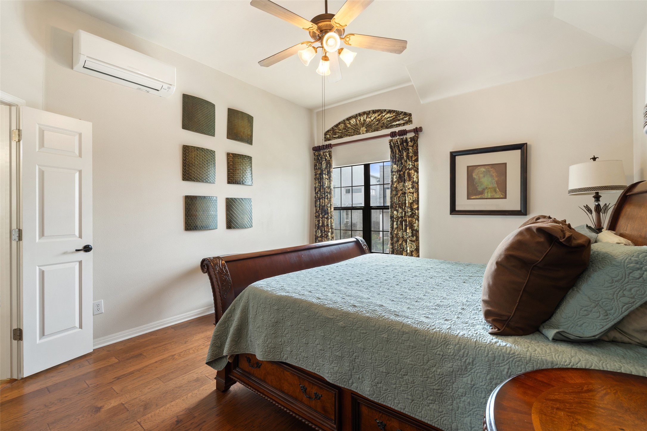 6006 Seville Drive Austin, TX 78724 - Photo 24 of 38 a bedroom with a bed and a chandelier