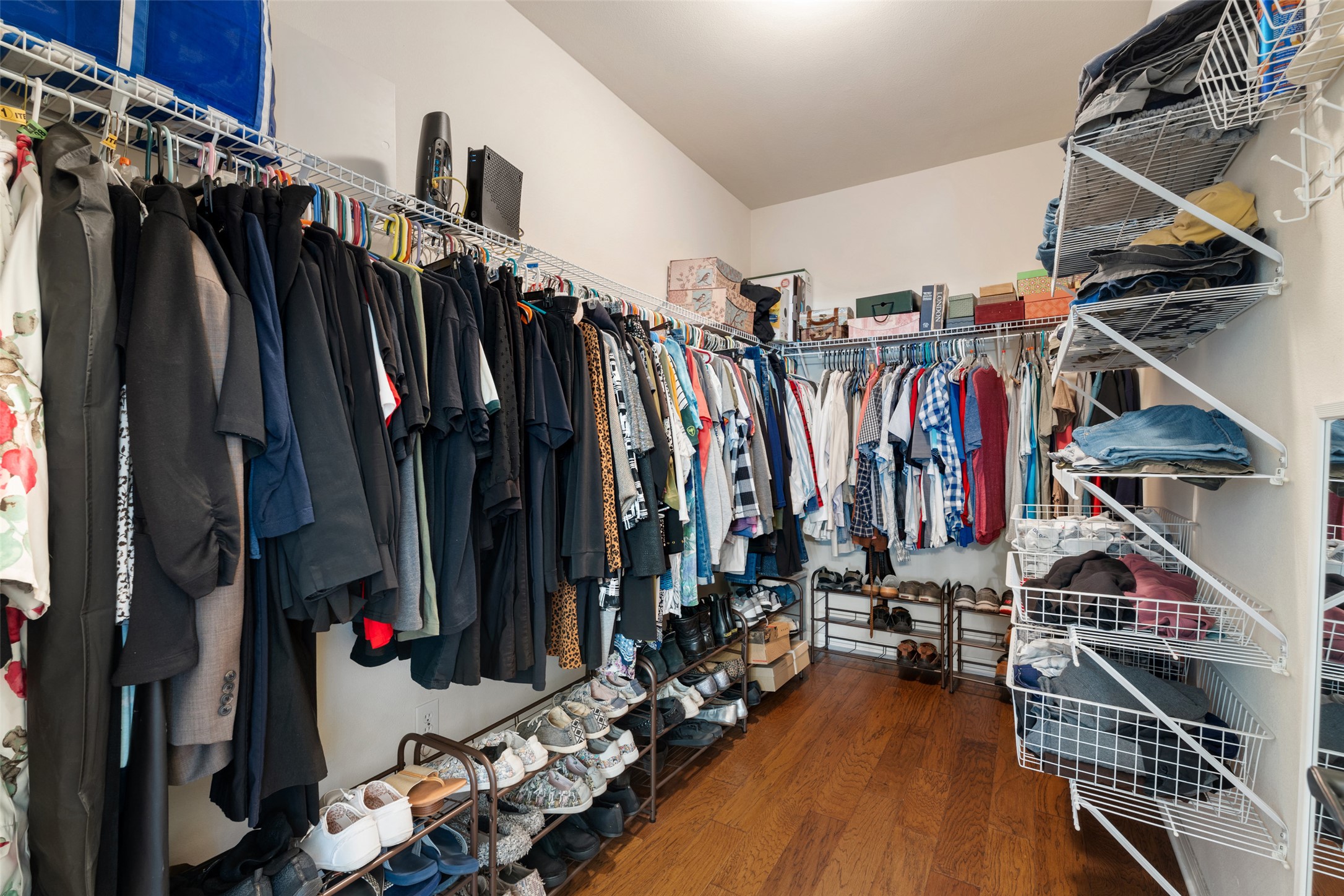 6006 Seville Drive Austin, TX 78724 - Photo 25 of 38 a view of walk in closet with clothes and shoes