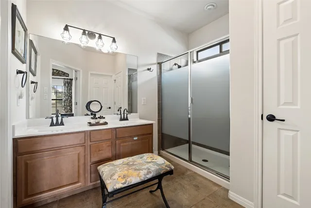 a spacious bathroom with a shower sink and mirror