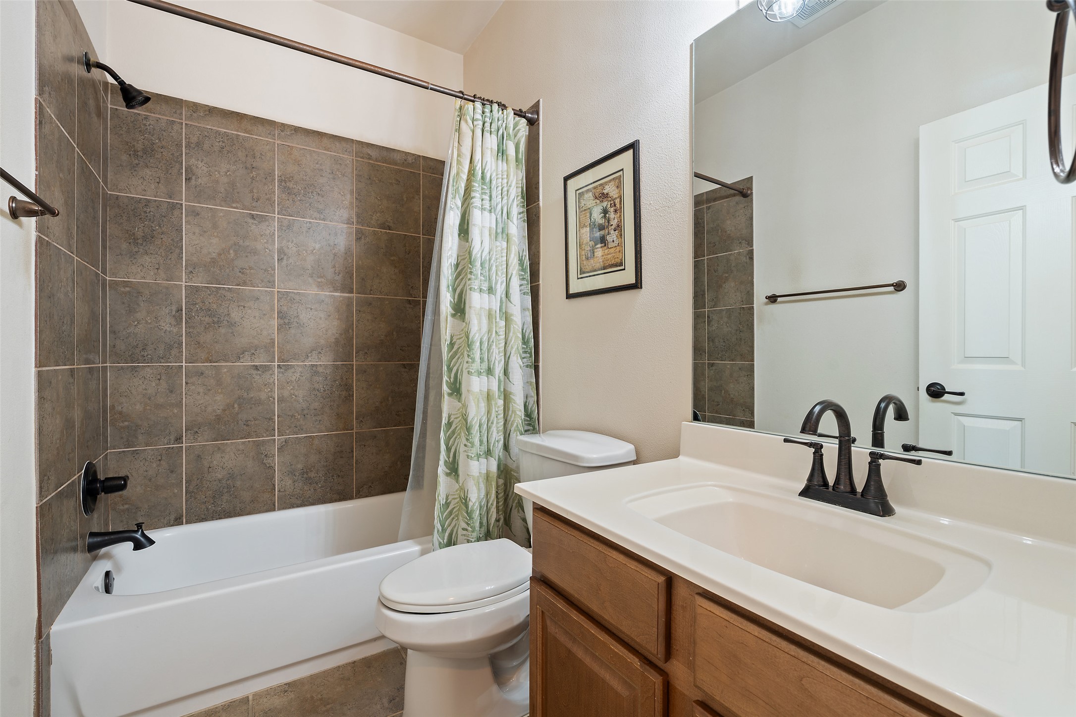 6006 Seville Drive Austin, TX 78724 - Photo 29 of 38 a bathroom with a sink a toilet and shower