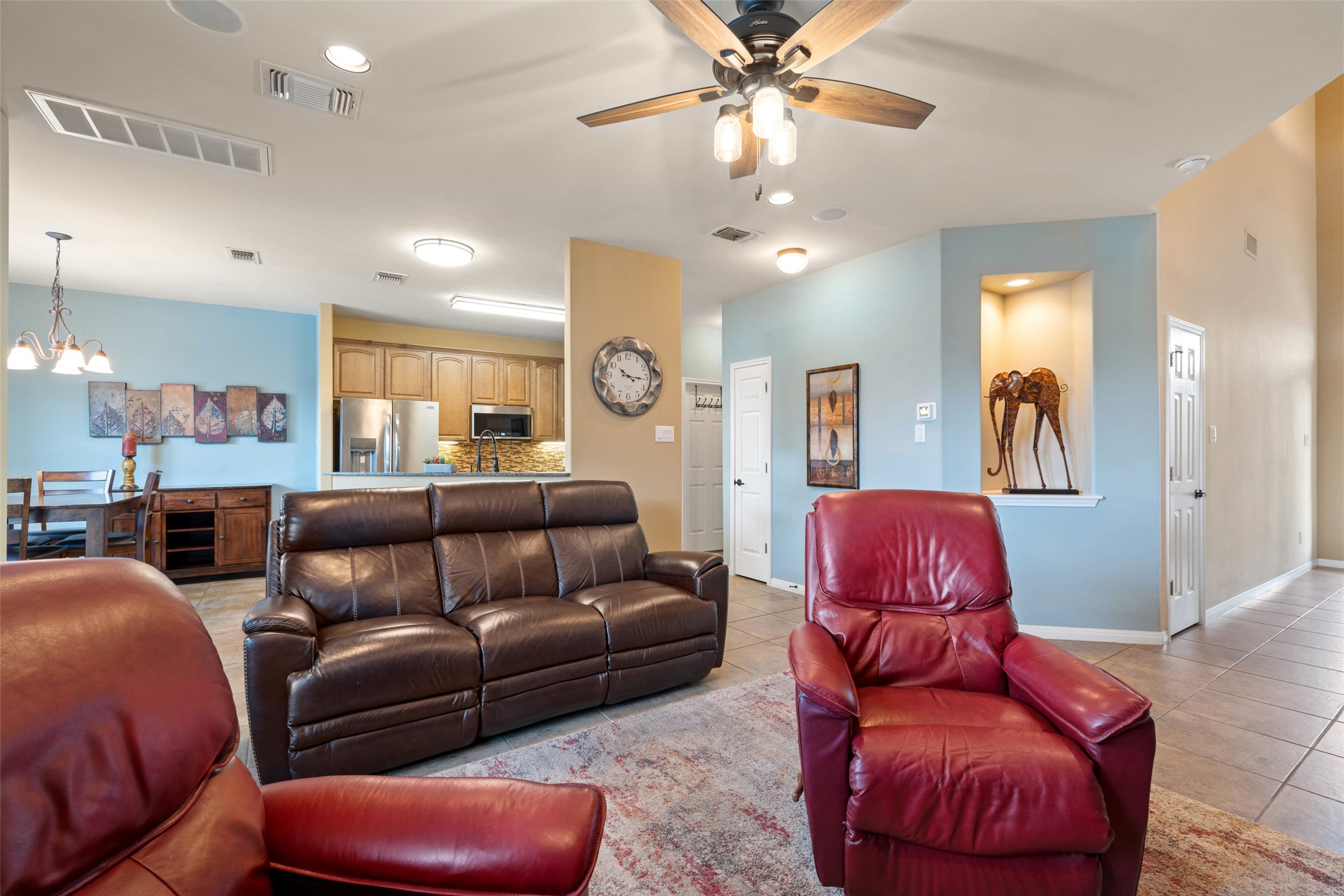 6006 Seville Drive Austin, TX 78724 - Photo 3 of 38 a living room with furniture a ceiling fan and a chandelier