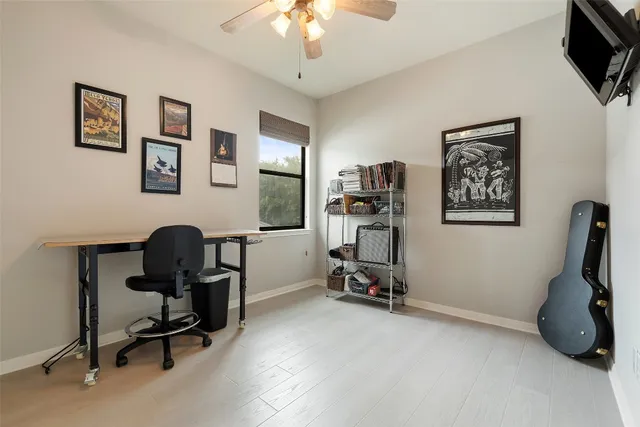 a view of a workspace with furniture and a window