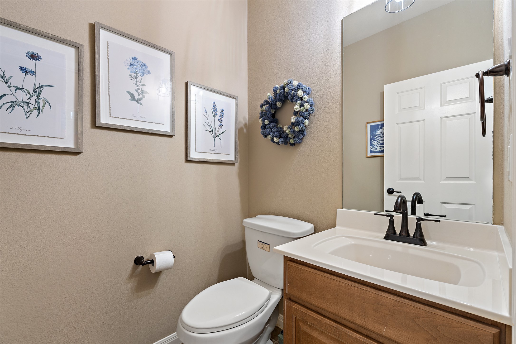 6006 Seville Drive Austin, TX 78724 - Photo 31 of 38 a bathroom with a toilet a sink and mirror