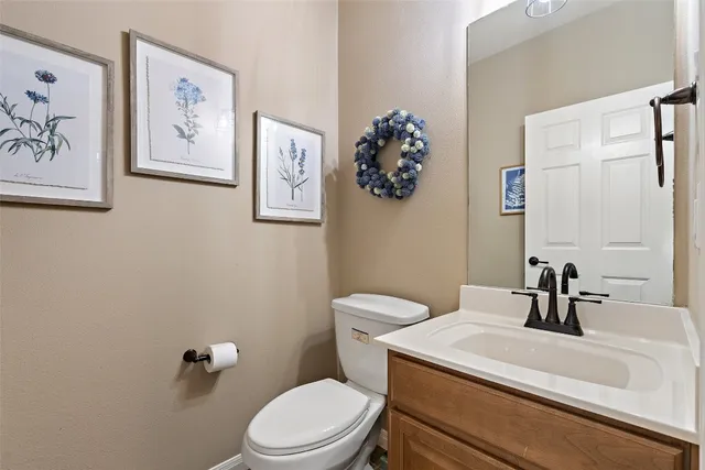 a white toilet sitting next to a bathroom sink